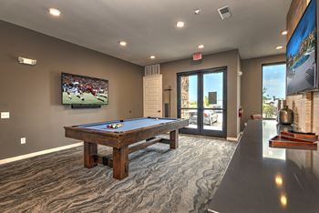 a games room with a pool table and a tv  at Watermark on Twenty Mile, Parker